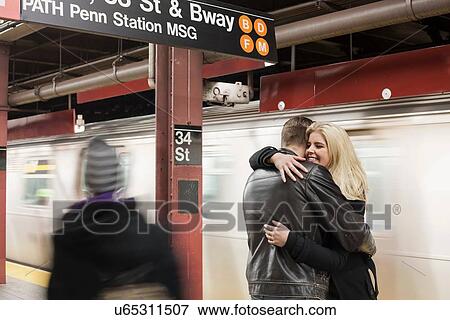 Romantic young couple hugging on New York City subway platform, New York, USA View Large Photo Image Stock Photo - Romantic young couple hugging on New York City subway platform, New York, USA. Fotosearch