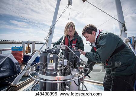 Scientists assembling sea water sampling experiment on research ship View Large Photo Image Stock Photograph - Scientists assembling sea water sampling experiment on research ship. Fotosearch