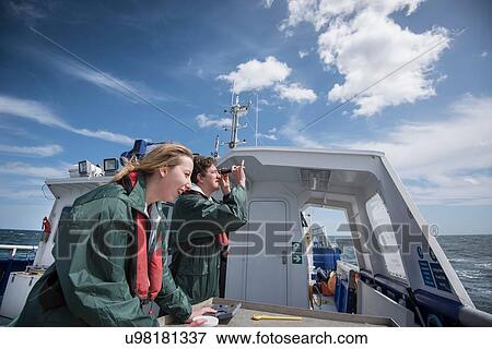 Stock Photo - Scientists inspecting plankton samples on research ship. Fotosearch