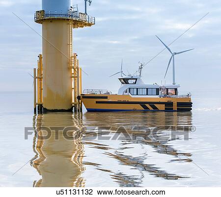 Service boat and wind turbine at offshore windfarm View Large Photo Image Stock Image - Service boat and wind turbine at offshore windfarm. Fotosearch