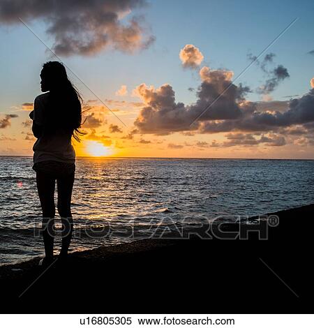 Silhouette of young woman watching sunrise, Kaaawa beach, Oahu, Hawaii, USA View Large Photo Image Stock Photography - Silhouette of young woman watching sunrise, Kaaawa beach, Oahu, Hawaii, USA. Fotosearch