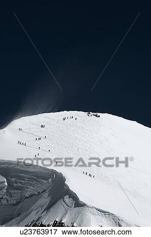 Stock Photo - Skiers on mountain in distance, Zermatt, Valais, Switzerland. Fotosearch