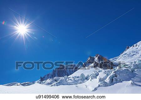 Snow covered landscape and blue sky, Mont Blanc massif, Graian Alps, France View Large Photo Image Stock Photograph - Snow covered landscape and blue sky, Mont Blanc massif, Graian Alps, France. Fotosearch