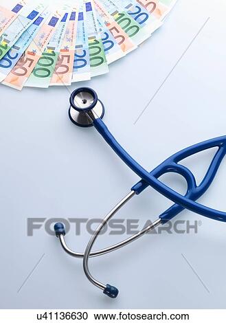 Stock Image - Stethoscope next to Euro notes. Fotosearch