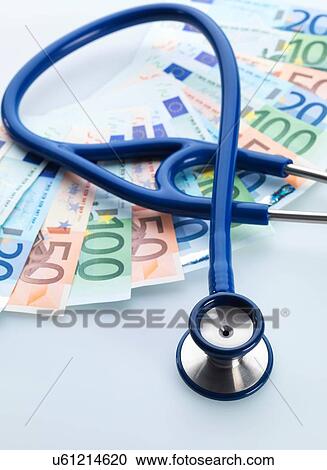 Stock Image - Stethoscope next to Euro notes. Fotosearch