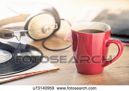 Still life of black coffee, headphones and vinyl record View Large Photo Image Stock Photo - Still life of black coffee, headphones and vinyl record. Fotosearch