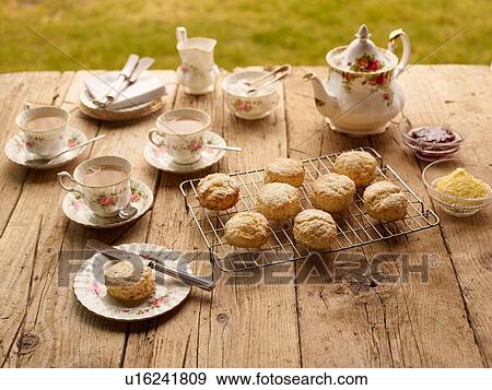 Table with afternoon tea of with fresh baked scones with jam and clotted cream View Large Photo Image Stock Photo - Table with afternoon tea of with fresh baked scones with jam and clotted cream. Fotosearch