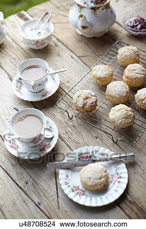 Table with fresh scones and afternoon tea View Large Photo Image Picture - Table with fresh scones and afternoon tea. Fotosearch