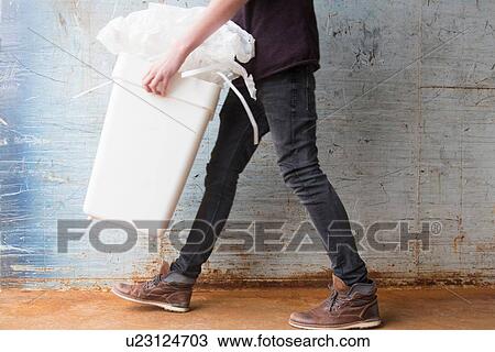 Teenage boy carrying bin with recyclable paper waste View Large Photo Image Stock Image - Teenage boy carrying bin with recyclable paper waste. Fotosearch