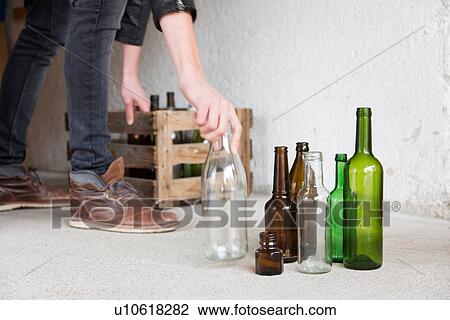Teenage boy placing empty bottles into wooden crate in garage View Large Photo Image Stock Image - Teenage boy placing empty bottles into wooden crate in garage. Fotosearch