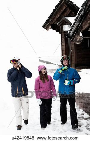 Stock Photo - Three friends wearing skiwear. Fotosearch
