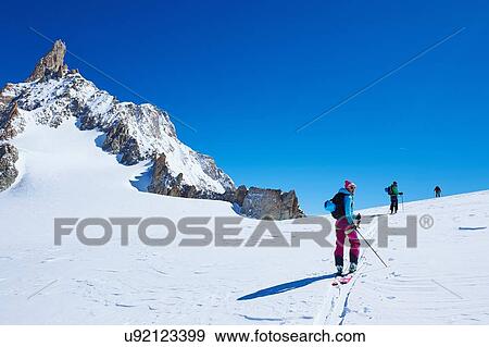 Three mature adult skiers moving up Mont Blanc massif, Graian Alps, France View Large Photo Image Stock Photo - Three mature adult skiers moving up Mont Blanc massif, Graian Alps, France. Fotosearch