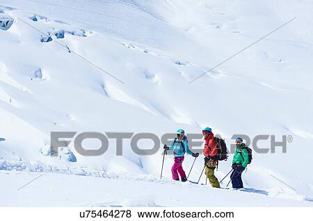 Stock Photo - Three mature adult skiers on Mont Blanc massif, Graian Alps, France. Fotosearch