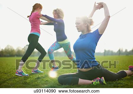 Three women exercising and stretching in the park View Large Photo Image Stock Image - Three women exercising and stretching in the park. Fotosearch
