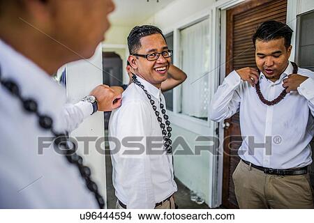 Three young men preparing for Hawaiian wedding wearing kukui nut beads, Kaaawa, Oahu, Hawaii, USA View Large Photo Image Picture - Three young men preparing for Hawaiian wedding wearing kukui nut beads, Kaaawa, Oahu, Hawaii, USA. Fotosearch