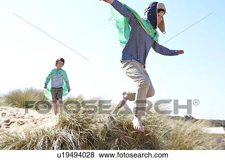 Two young boys, wearing fancy dress, playing on beach View Large Photo Image Stock Photo - Two young boys, wearing fancy dress, playing on beach. Fotosearch