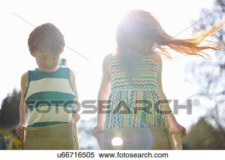 Two young children having sack race View Large Photo Image Stock Photography - Two young children having sack race. Fotosearch