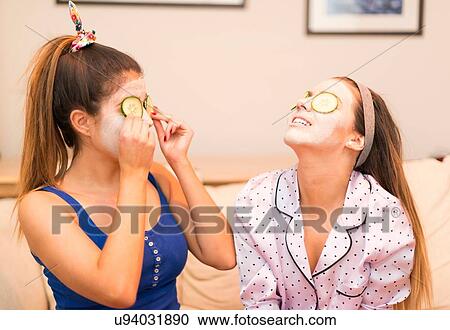 Two young women wearing face masks View Large Photo Image Stock Image - Two young women wearing face masks. Fotosearch