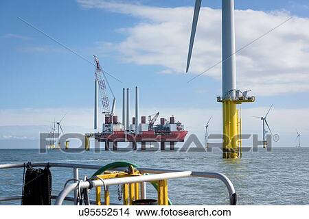 Picture - View from boat of offshore wind farm and construction ship. Fotosearch