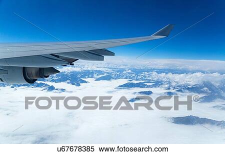 Stock Photography - View of airplane wing through airplane window. Fotosearch