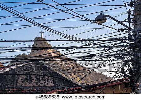 Stock Photography - View of Christ the Redeemer statue through telegraph wires and cables, Rio De Janeiro, Brazil. Fotosearch
