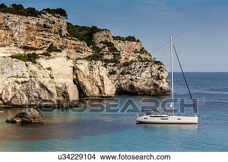 Picture - View of sailboat, Cala Macarella, Menorca, Spain. Fotosearch