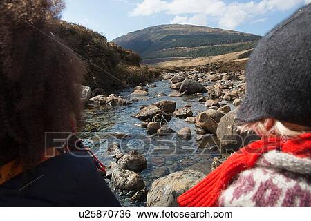 Stock Photograph - Woman and boy looking at view, Fairy Pools, Isle of Skye, Hebrides, Scotland. Fotosearch