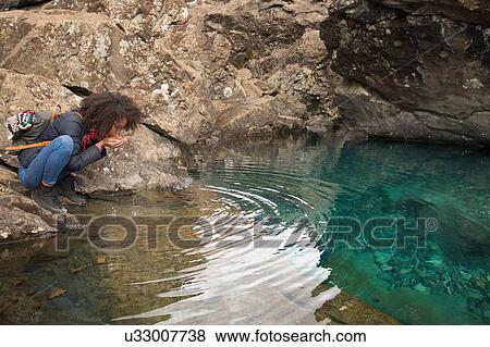 Woman drinking water from cupped hands, Fairy Pools, Isle of Skye, Hebrides, Scotland View Large Photo Image Stock Photo - Woman drinking water from cupped hands, Fairy Pools, Isle of Skye, Hebrides, Scotland. Fotosearch