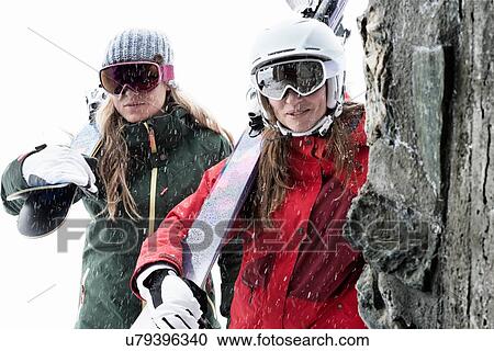 Women wearing ski goggles holding skis View Large Photo Image Stock Image - Women wearing ski goggles holding skis. Fotosearch