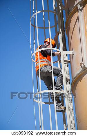 Worker climbing smoke stack ladder View Large Photo Image Stock Image - Worker climbing smoke stack ladder. Fotosearch