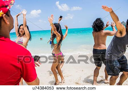 Young adult friends dancing on Lanikai Beach, Oahu, Hawaii, USA View Large Photo Image Stock Image - Young adult friends dancing on Lanikai Beach, Oahu, Hawaii, USA. Fotosearch