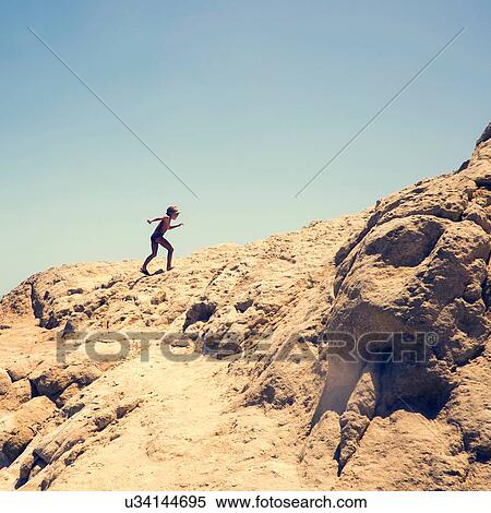 Stock Photography - Young boy climbing sandy hill, Hurgada, Red Sea, Egypt. Fotosearch