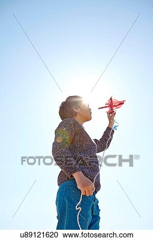 Young boy flying kite View Large Photo Image Stock Image - Young boy flying kite. Fotosearch