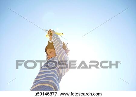 Stock Photo - Young boy flying kite. Fotosearch