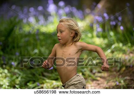 Young boy running through bluebell forest View Large Photo Image Stock Photo - Young boy running through bluebell forest. Fotosearch