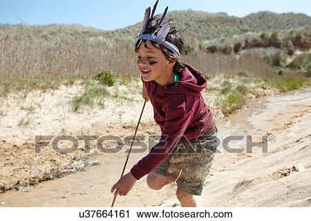 Young boy, wearing fancy dress, running on sand View Large Photo Image Stock Image - Young boy, wearing fancy dress, running on sand. Fotosearch