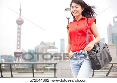 Young businesswoman, walking, outdoors, Shanghai, China View Large Photo Image Stock Image - Young businesswoman, walking, outdoors, Shanghai, China. Fotosearch
