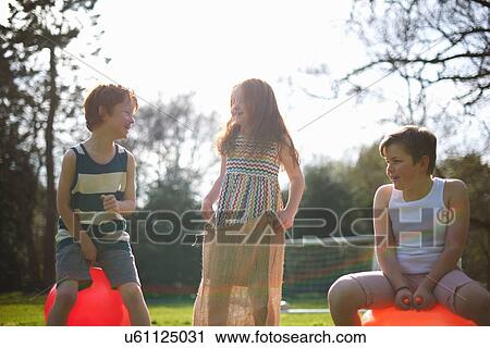Young children on inflatable hopper and standing in sack, ready for race View Large Photo Image Stock Image - Young children on inflatable hopper and standing in sack, ready for race. Fotosearch