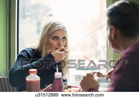 Young couple eating lunch in cafe View Large Photo Image Stock Photo - Young couple eating lunch in cafe. Fotosearch