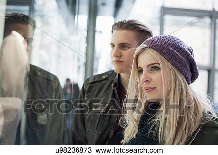 Stock Image - Young couple gazing at shop window, New York, USA. Fotosearch
