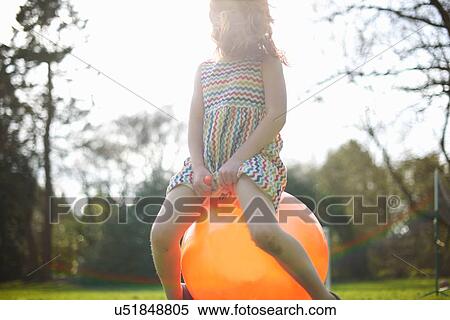 Young girl bouncing on inflatable hopper View Large Photo Image Stock Photography - Young girl bouncing on inflatable hopper. Fotosearch