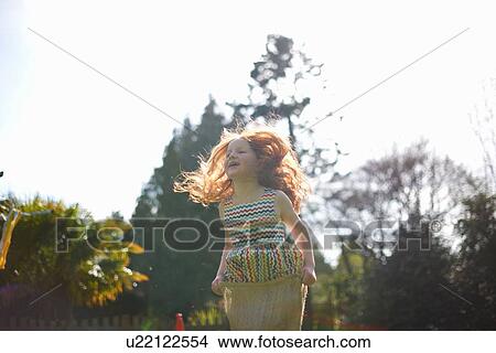 Young girl in sack race, low angle view View Large Photo Image Picture - Young girl in sack race, low angle view. Fotosearch
