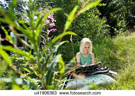 Young girl sitting in rural environment with sketchbook View Large Photo Image Stock Image - Young girl sitting in rural environment with sketchbook. Fotosearch