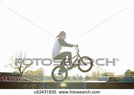 Young man doing stunt on bmx at skatepark View Large Photo Image Stock Photography - Young man doing stunt on bmx at skatepark. Fotosearch