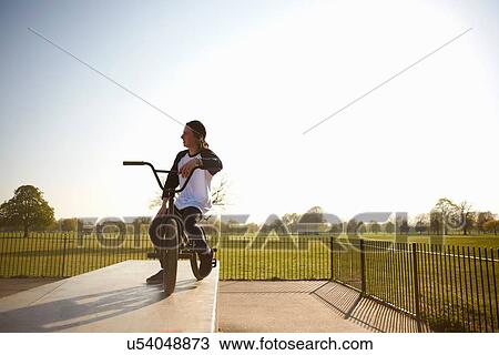 Stock Image - Young man on bmx bike at skatepark. Fotosearch