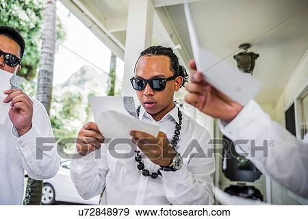 Young men preparing for Hawaiian wedding wearing kukui nut beads, Kaaawa, Oahu, Hawaii, USA View Large Photo Image Stock Photo - Young men preparing for Hawaiian wedding wearing kukui nut beads, Kaaawa, Oahu, Hawaii, USA. Fotosearch