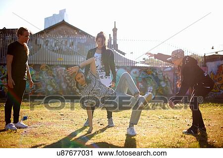 Stock Image - Young woman in breakdancing freeze. Fotosearch