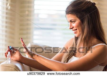Young woman looking at newly painted nails View Large Photo Image Stock Photo - Young woman looking at newly painted nails. Fotosearch