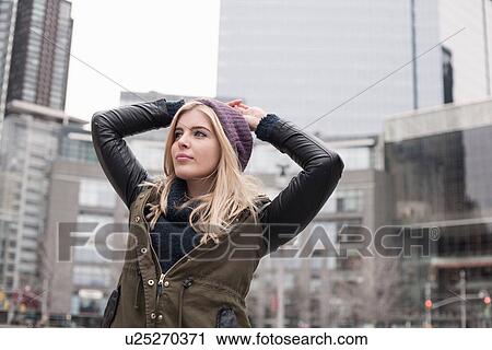 Young woman looking out from street with hands on head, New York, USA View Large Photo Image Stock Image - Young woman looking out from street with hands on head, New York, USA. Fotosearch