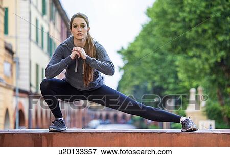 Young woman stretching View Large Photo Image Stock Photo - Young woman stretching. Fotosearch